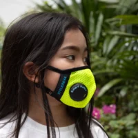 girl wearing a yellow styleseal pro face mask with smart valve